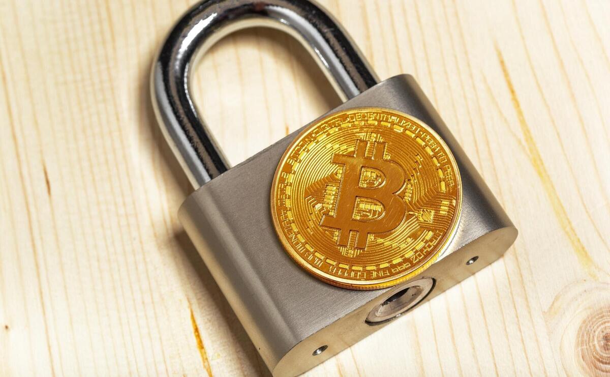 Gold bitcoin and padlock
